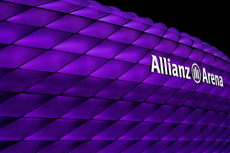 Close-up of Allianz Arena's illuminated purple facade panels at night, Munich