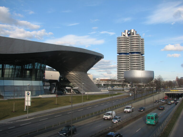 BMW Welt curved architecture and the four-cylinder BMW headquarters tower seen from the road, Munich