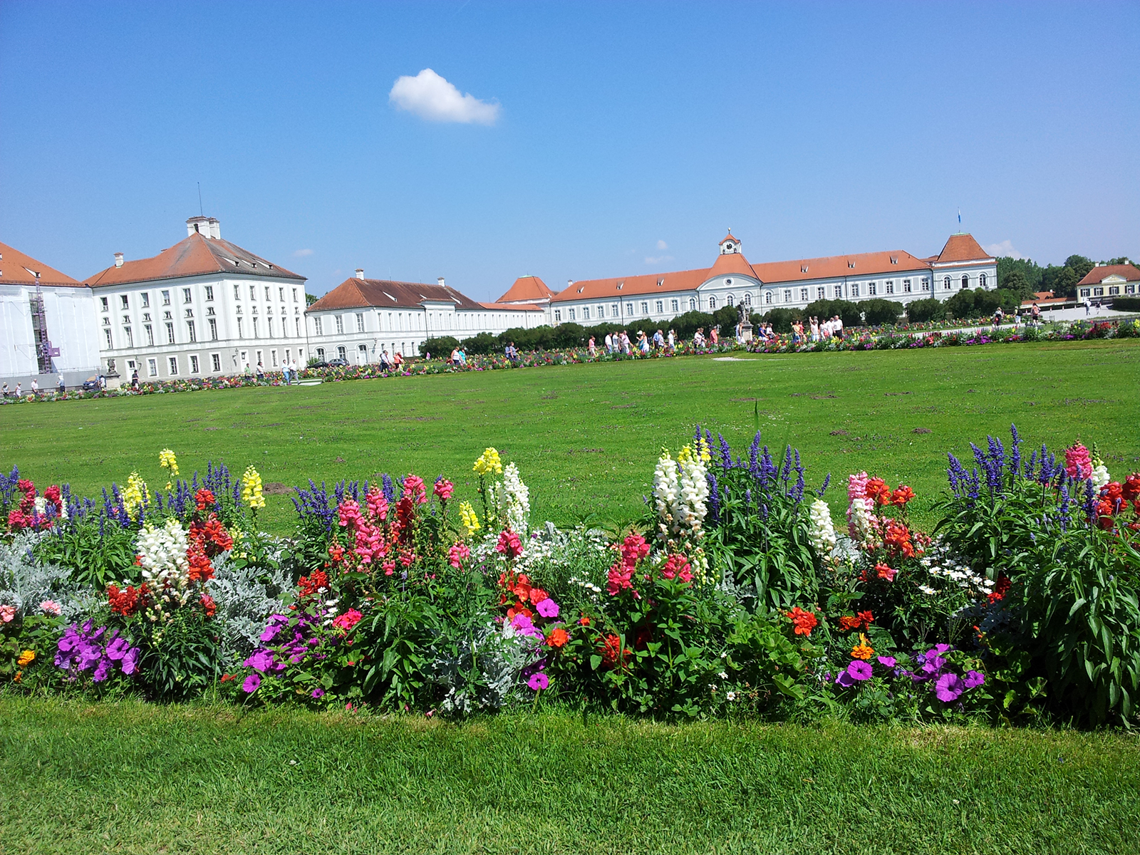 Schloss Nymphenburg palace and garden in summer with flowers and lawn