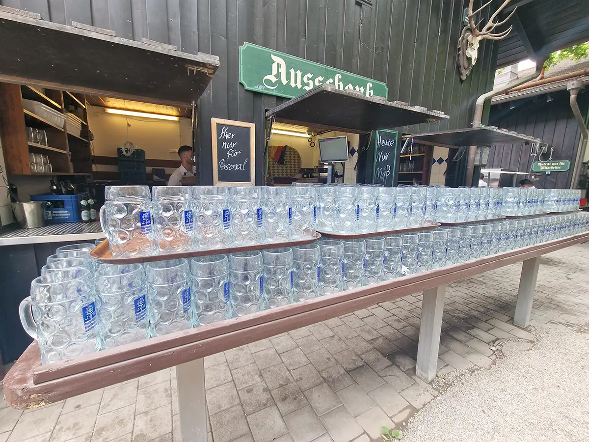 Rows of empty Masskrug beer mugs at a Munich beer garden Ausschank counter
