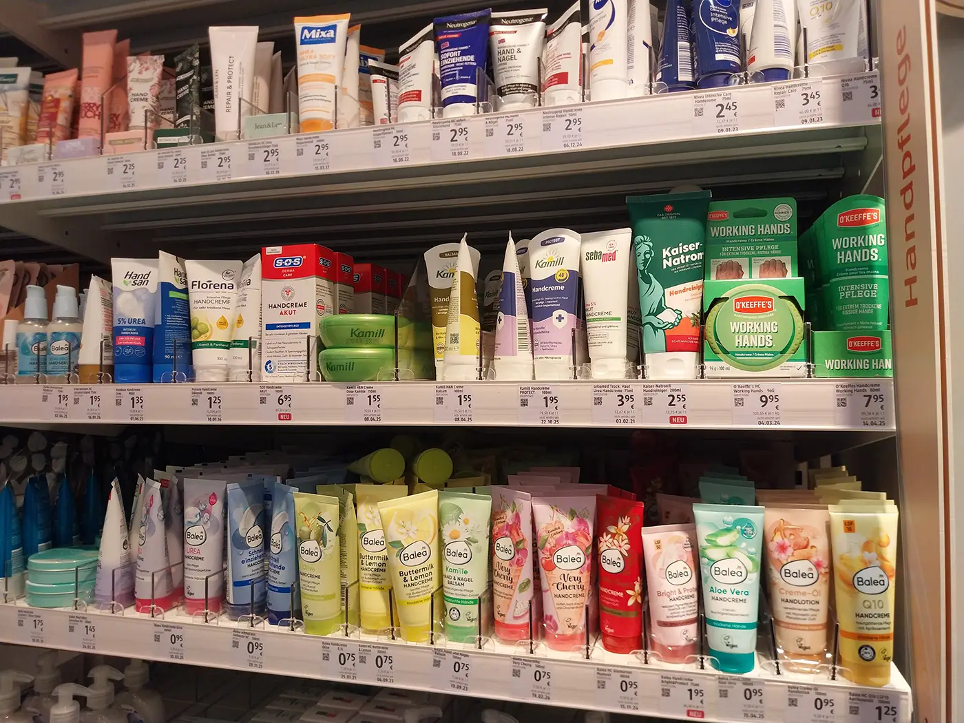 Hand cream shelves in a Munich drugstore with Balea and Kamill products
