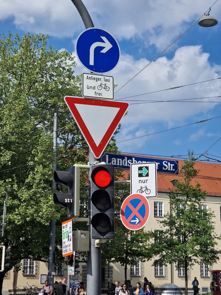 Munich traffic signs showing yield, direction, bicycle exception, and stopping rules
