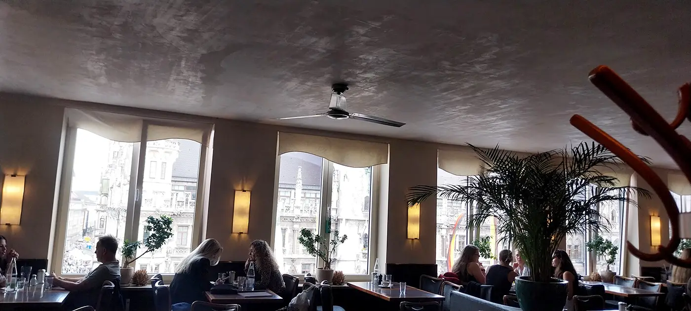 Window seats inside Glockenspiel Cafe above Marienplatz in Munich