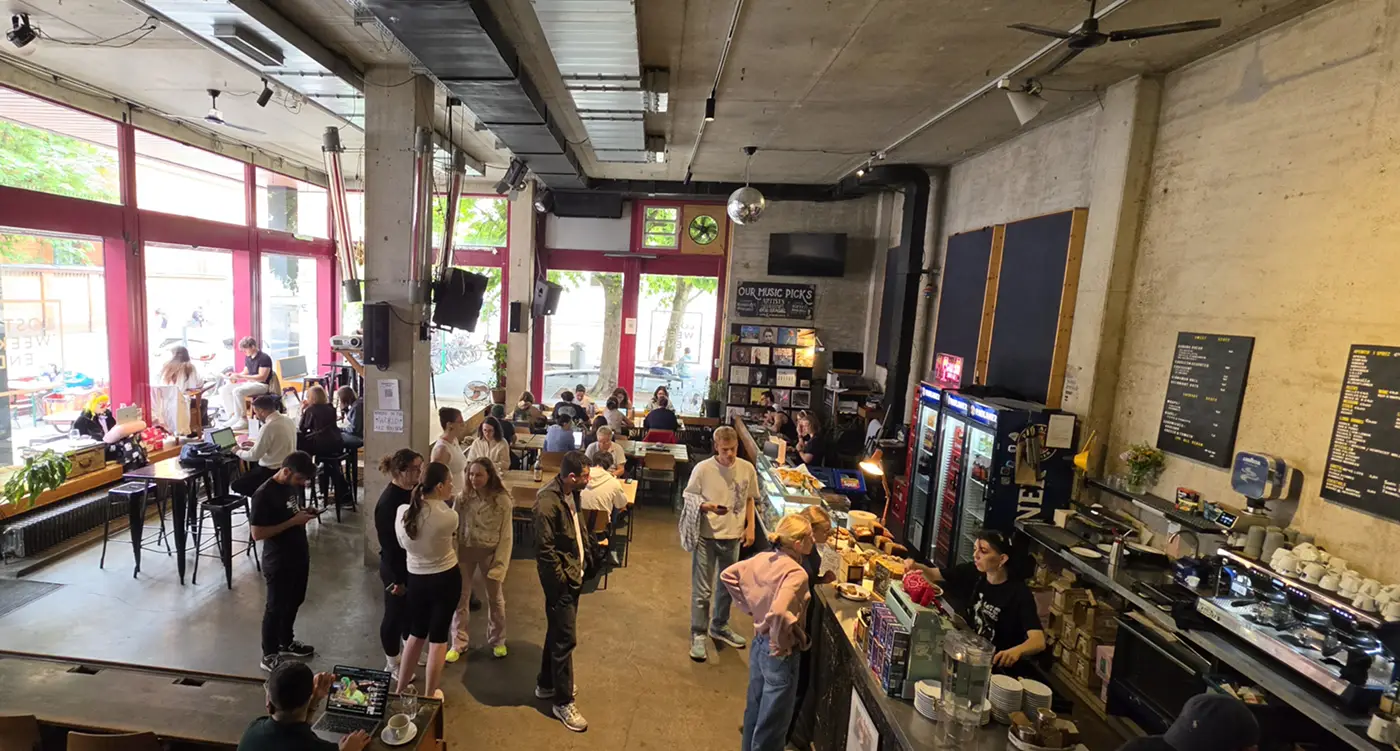 Interior of Lost Weekend cafe in Maxvorstadt Munich with students and coffee bar
