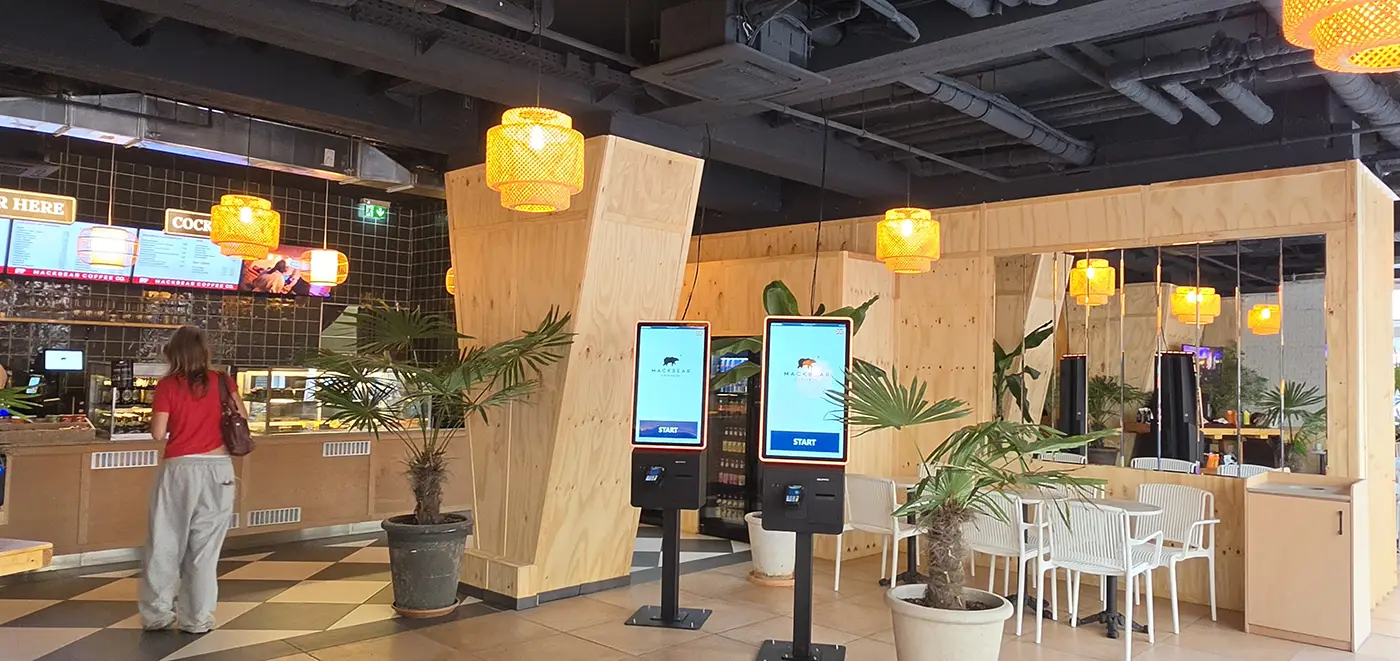 Interior of MACKBEAR Coffee in Munich with tables, plants, and laptop seats