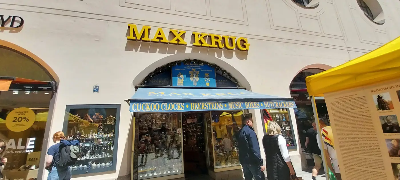 Max Krug souvenir shop near Marienplatz in Munich, with signs for cuckoo clocks, beer steins, music boxes, and nutcrackers