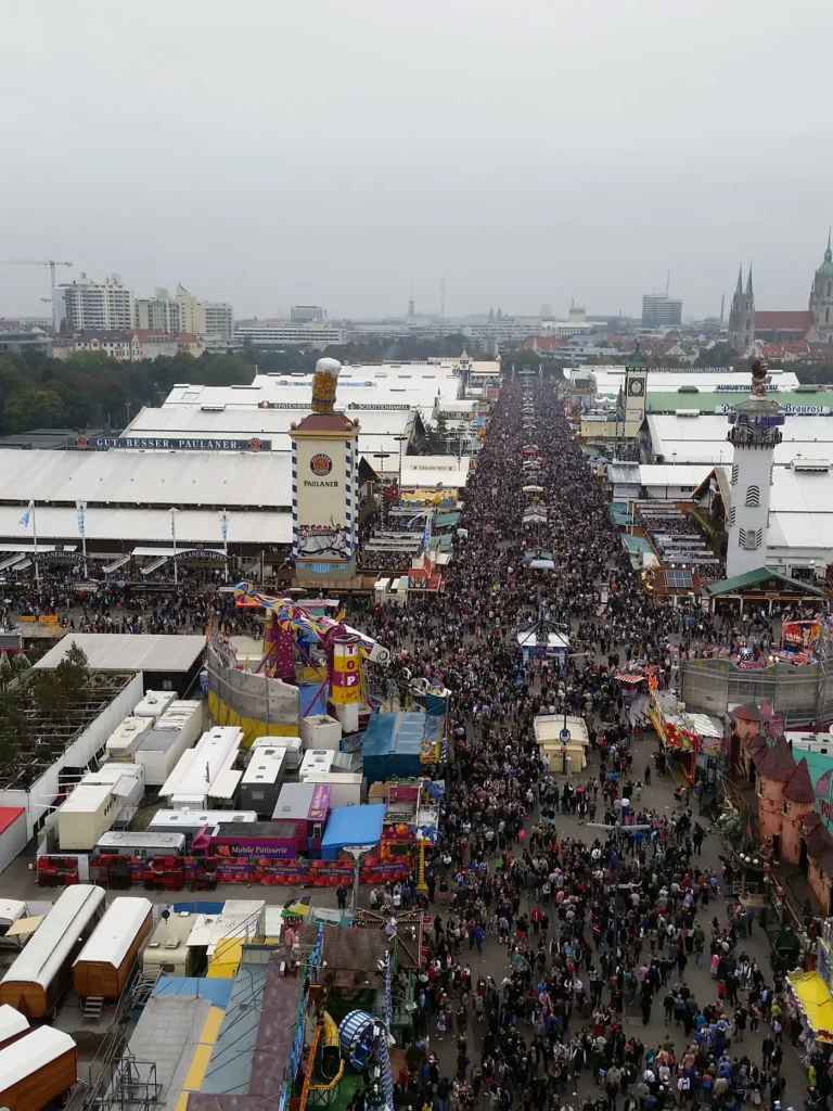 Crowds filling the main avenue between beer tents at Oktoberfest in Munich