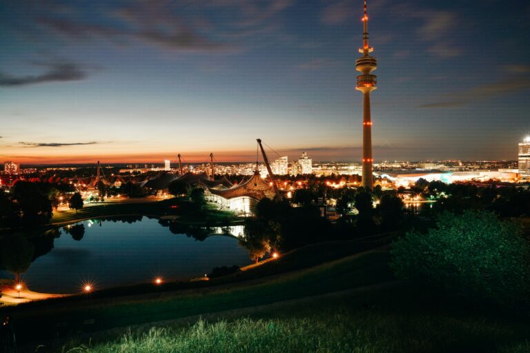 Olympiapark Munich at dusk before the August 12, 2026 partial solar eclipse and evening fireworks