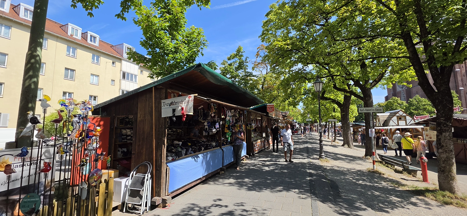Market stalls under the trees at Auer Jakobidult in Munich in July 2026