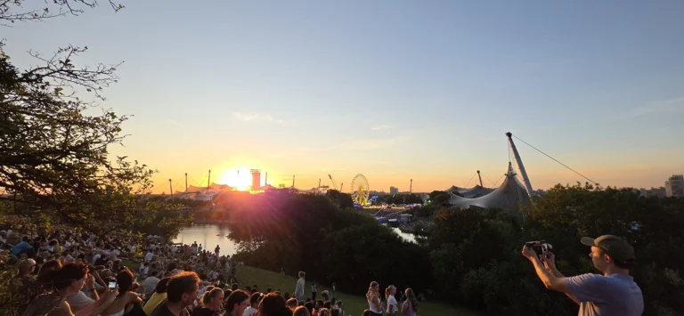 Sunset over Olympiapark from Olympiaberg during the August 2026 partial solar eclipse