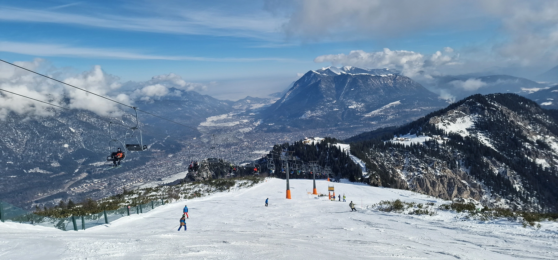 Open ski slope above Garmisch-Partenkirchen with a wide view down into the valley at Garmisch-Classic